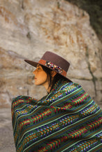 Load image into Gallery viewer, model wearing a green handmade wool rebozo and a brown hat boho vibes